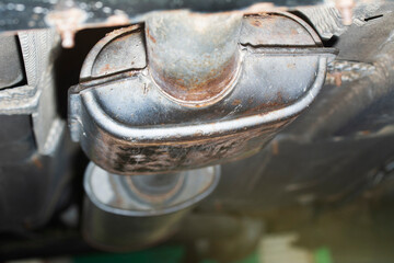 Defocused blurred view of car muffler. Car exhaust pipe