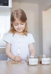 Little girl counting her savings.