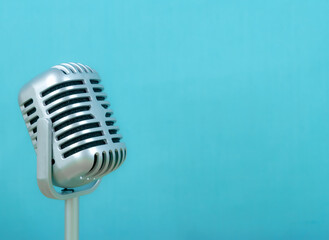 Fototapeta na wymiar Retro microphone on blue background