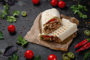Delicious shawarma and lavash tacos on a dark stone table. Fast food restaurant. Healthy option of...