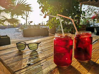 Cold drinks on a wooden table. Non alcoholic coctails in unidentified local bar in Cape Verde,...