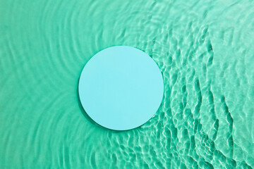 Mint square podium on the green water surface background. Flat lay, copy space. 