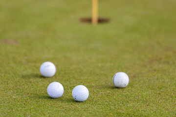 Russia. Saint-Petersburg. Golf balls near the hole. Strawberry Fields Golf Club.