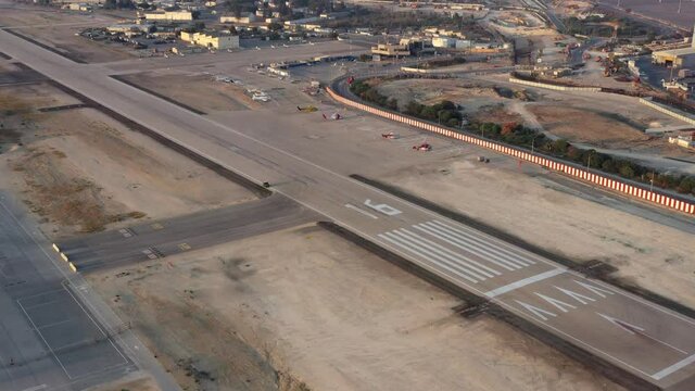 Haifa airport and runway with the city skyline in the background, Aerial view.