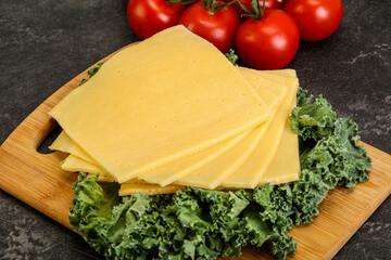 Sliced Gauda cheese over board