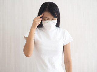 Young woman has headache, on white background. closeup photo, blurred.