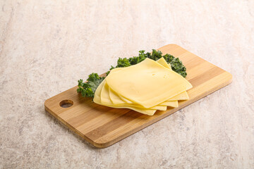 Sliced Gouda cheese over board