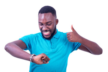 portrait of a young man looking at watch, happy.