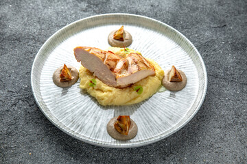 Grilled chicken fillet with mashed potatoes and fried mushrooms. Ready menu for the restaurant. Neutral gray blue textured background