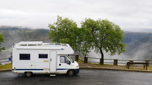 Caravan camping in mountains at Penedo Durao lookout in north Portugal. Rainy cloudy weather. Traveling by motorhome. Place to visit.