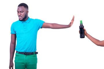 handsome young man refusing bottle of beer.