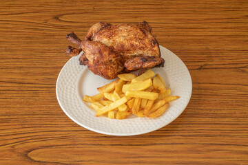 Whole roasted chicken with crispy and toasted skin garnished with homemade chips