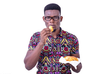 handsome young man eating croissant.