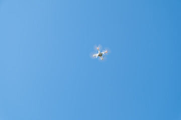 Drone or quadrocopter while flying in the sky.