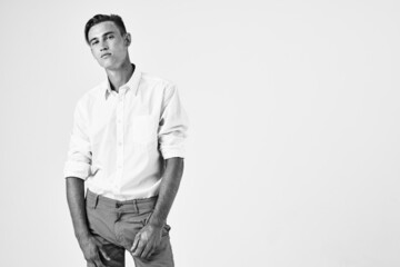 Fototapeta premium handsome man in white shirt fashion hairstyle studio lifestyle