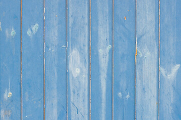 Street abstract of blue paint on wooden boards.