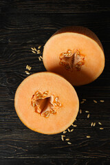 Ripe melon halves on rustic wooden table