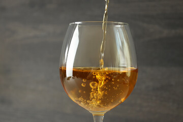 Wine is poured into a glass, close up