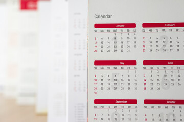 Close up calendar page dates and month background business planning appointment meeting concept