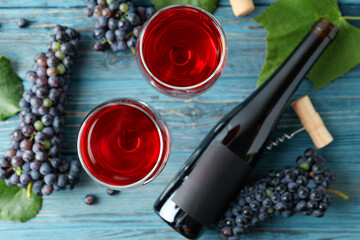 Obraz na płótnie Canvas Red wine, grape, cork and corkscrew on wooden table