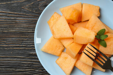 Concept of fresh food with melon pieces on rustic wooden table