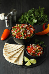 Mexican food concept with Pico de Gallo on dark wooden table