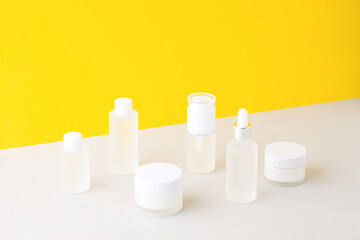 Composition with skin care products on yellow and grey background. Close up, copy space