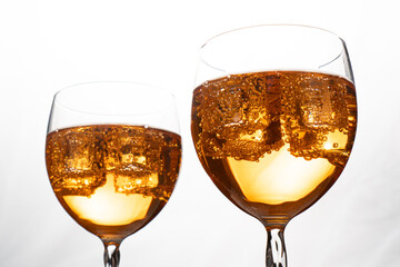 Homemade Aperol spritz. Orange sparkling cocktails in a glass upfront the light. Ice in cocktails