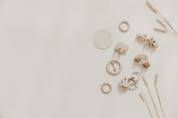 Baby wooden toy eco natural. Scandinavian nordic style on beige background. Mockup. Top view. Copy space.
