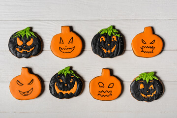 flay lay with spooky pumpkin shape halloween cookies on white surface