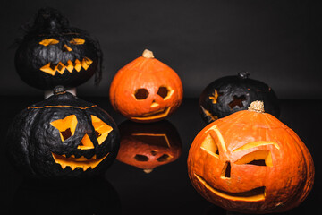 creepy orange and black pumpkins on dark background