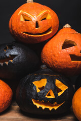 stack of spooky halloween pumpkins isolated on black