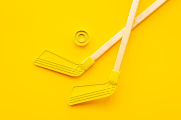 Two hockey sticks and puck. Competitive sports equipment