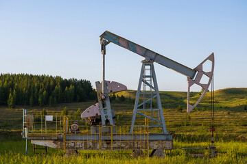 Fototapeta na wymiar Working oil pump from oil field. Industrial equipment. Industrial equipment. Bashkortostan, Russia - 12 June, 2021.
