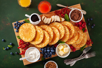 american pancake board with bacon berries maple syrup butter