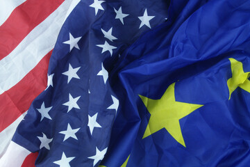 United States and European Union flags close up.