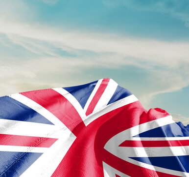 United Kingdom flag cloth fabric waving on the sky with beautiful sun light - Image