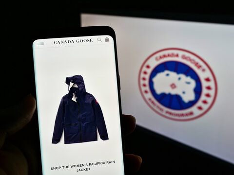 STUTTGART, GERMANY - May 30, 2021: Person Holding Mobile Phone With Website Of Company Canada Goose Holdings Inc. On Screen With Logo.