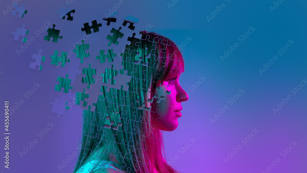 Wall mural Conceptual image with portrait of young woman made of pieces of puzzle. Emotional chaos in a person's head. Contemporary art collage