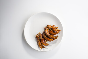 Chinese fried Chicken Feet on the plate isolated on white background