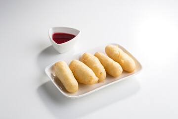 Chinese Cuisine dessert Milk Mousse Fried in Soft Dough with sauce isolated on white background