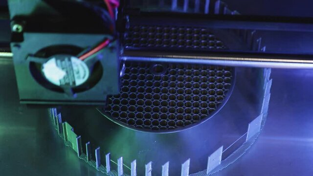 3D printer working close-up. High-tech fast printing of bulk plastic parts with heated polymer materials. Machine creates a modern prototype object