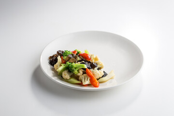 stir fry wok style mushroom, brocoli and cauliflower isolated on white background