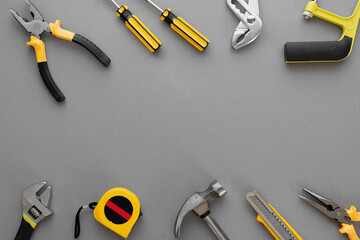 Flat lay composition with construction and home repair tools tools on grey background, space for text