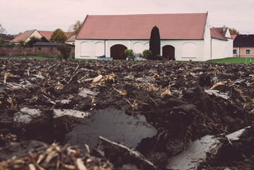 Shot of loose and cracked soil in the courtyard of a cottage with a protective covering