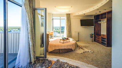 Modern interior of bedroom in studio apartment. Breakfast on bed.