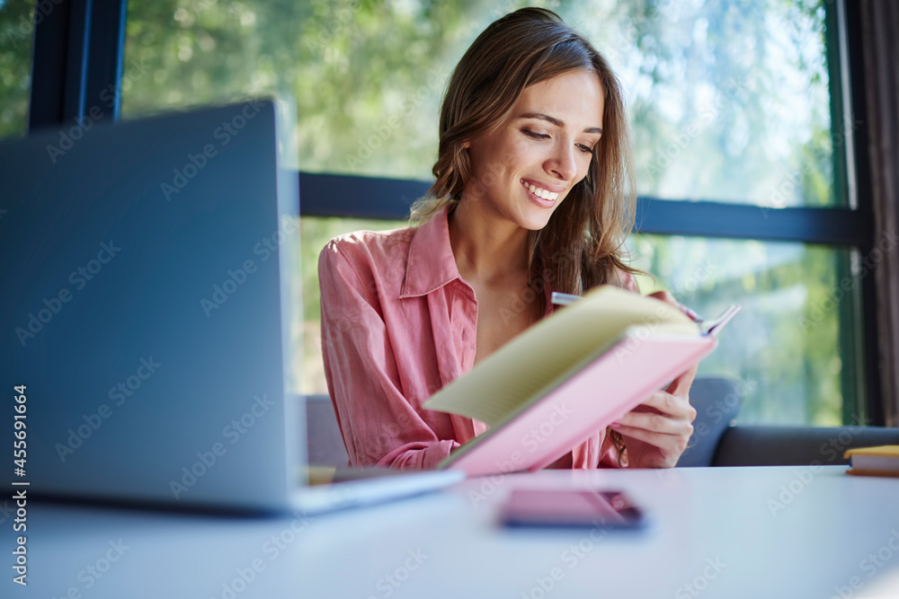 Poster happy caucaisan student with digital laptop technology e learning at table desktop enjoying daytime 