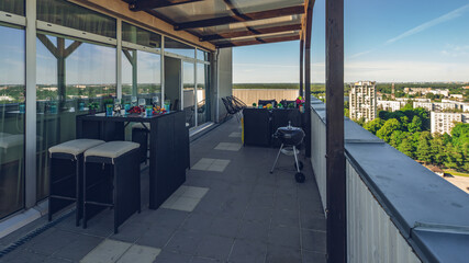 Lounge zone on outdoor terrace in modern luxury apartment.