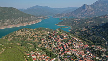 Fototapeta na wymiar Aerial drone photo of small picturesque village of Lidoriki built near lake and dam of Mornos a clean water supply for Attica, Greece