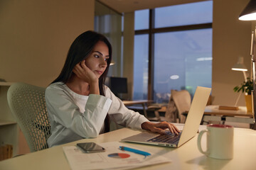 European businesswoman working on laptop in office